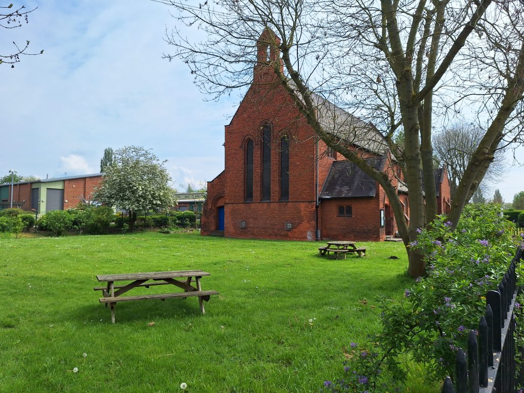 Outside of church with picnic tables